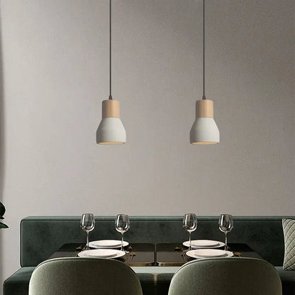 Two minimalist pendant lamps with matte white ceramic shades and wood accents for bedroom decorbites cement concrete style