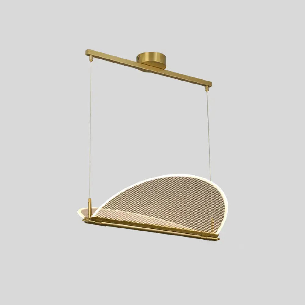 A modern gold-toned minimalistic acrylic dining pendant light with a curved mesh shade for folding island use