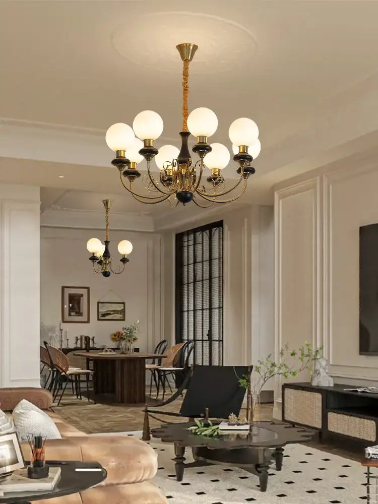 Gold-toned cream style led chandelier with frosted glass globes and black accents for dining room decorbites cream style