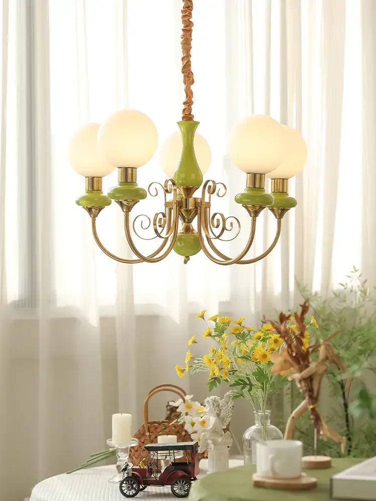 Vintage-style mint and gold cream style led chandelier with green ceramic body and frosted glass globes for dining room decorbites cream style