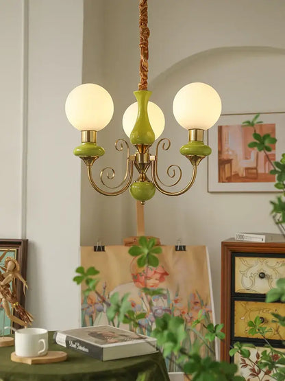 Mint and gold cream style led chandelier with three white globe bulbs olive green ceramic bases and brass arms for decorbites cream style