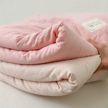 A soft pastel pink cotton summer cooling blanket with subtle textured weave and gentle folds for decorbites cotton summer use