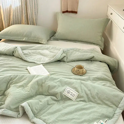 A soft mint green cotton summer cooling quilted comforter with subtle stripes and ribbed edge trim by decorbites cotton summer