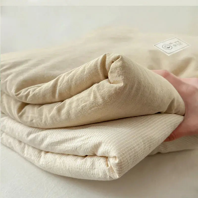 A soft cream-colored cotton summer cooling blanket with subtle ribbed texture for bedroom decorbites cotton summer use