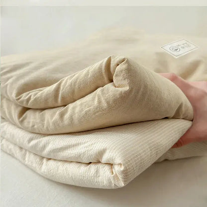 A soft cream-colored cotton summer cooling blanket with subtle ribbed texture for bedroom decorbites cotton summer use