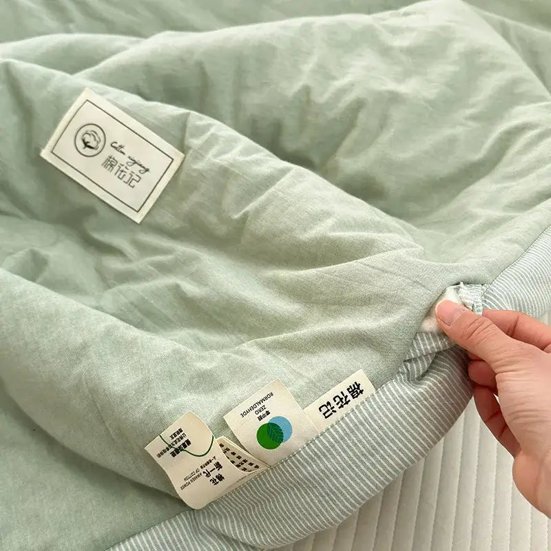 Light green quilted cotton summer cooling blanket with soft textured surface and striped fabric trim for decorbites cotton summer use