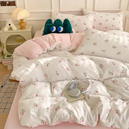 White duvet cover with pink cherry blossom prints and quilted texture from mint green and cream cartoon heart plant quilt set