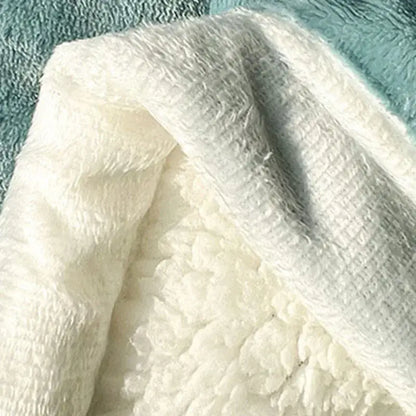 A plush mint green and cream decorbites cozy imitation lambs wool blanket with soft textured fleece and stitched edges