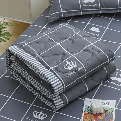 Gray quilted blanket with white grid stitching crown and love simple embroidery in decorbites daisy print quilt set