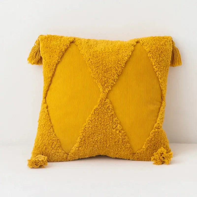 Vibrant mustard yellow diamond tassel cushion cover with textured corduroy fabric and plush tassels at each corner