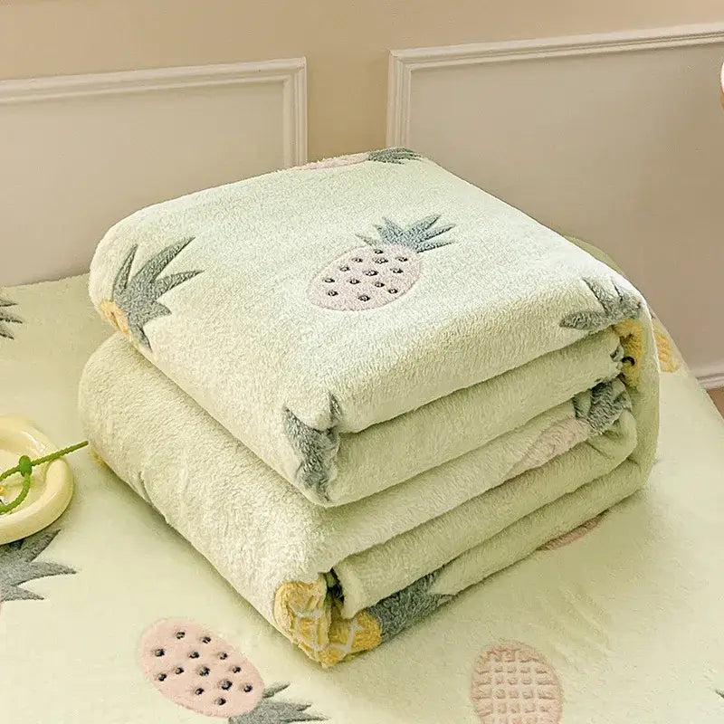 A soft mint green snowflake velvet blanket with light green plush fabric and embroidered pink gray pineapple designs decorbites dinosaur patterns