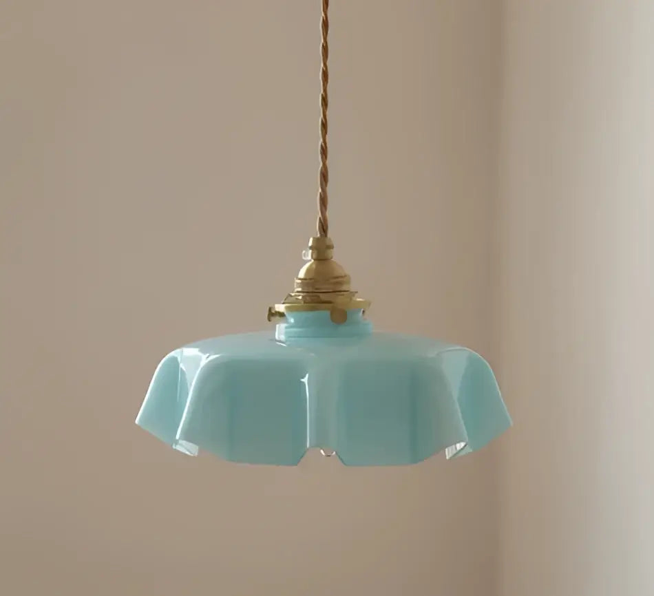 A delicate mint green fluted glass led wall lamp sconce with brass fixture and twisted cord for bedroom lighting