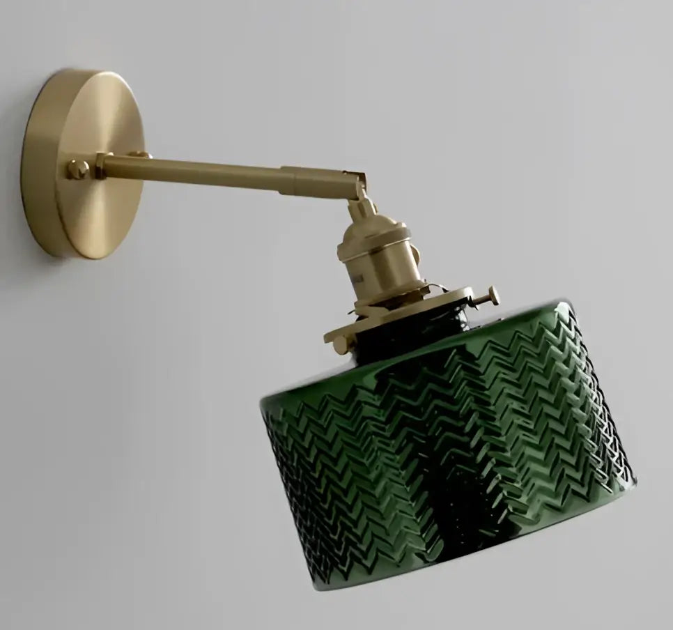 Mint green fluted glass led wall lamp sconce with textured chevron pattern mounted on a brass arm fixture