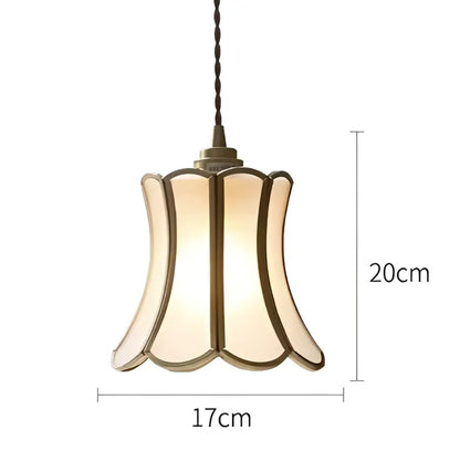 Vintage-style wall lamp sconce with warm cream glass shade brass trim and twisted black cord for bedroom lighting