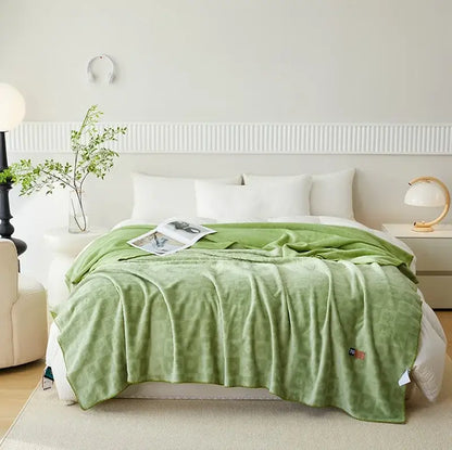Mint green jacquard milk velvet throw blanket with subtle texture ideal for bedroom decor and travel comfort by decorbites
