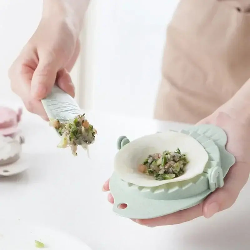 Mint green leaf silicone dumplings maker tool with a leaf-shaped design for easy dumplings making in the kitchen