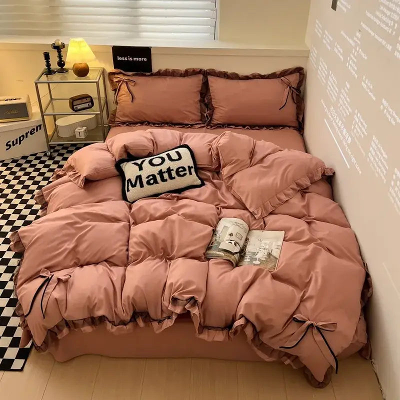 Pink ruffled quilted bedding set with black ribbon ties featuring decorbites cotton embroidery for bedroom decor