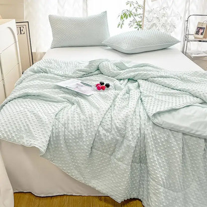 Light mint green quilted decorbites cooling massage blanket with textured raised dot pattern for bedroom comfort