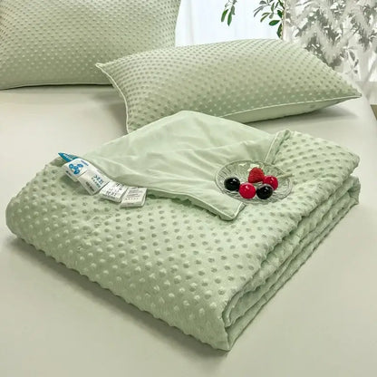 Soft mint green quilted decorbites cooling massage blanket with textured raised dot pattern for bedroom comfort