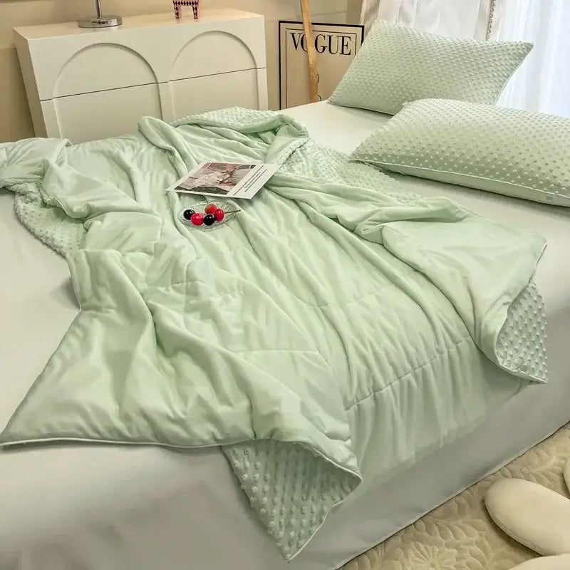 Soft mint green quilted decorbites cooling massage blanket with textured dotted underside for bedroom comfort