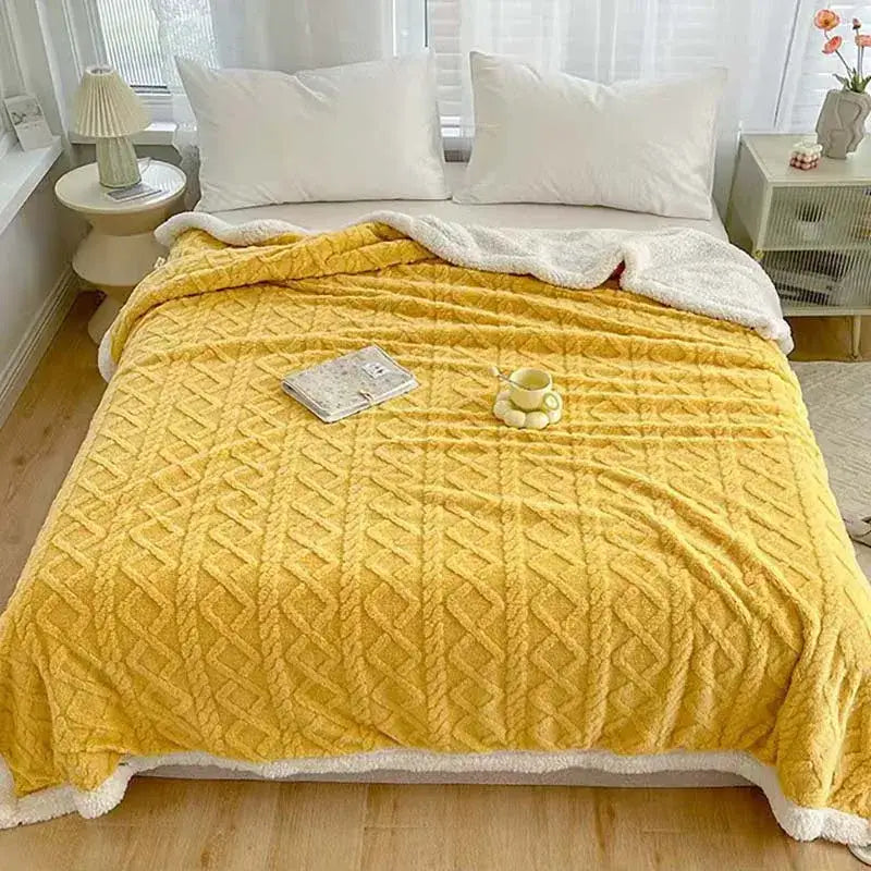 A cozy mustard-yellow decorbites coral fleece blanket with textured diamond-knit pattern and soft white fleece lining
