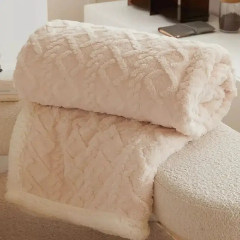 Cream-colored decorbites coral fleece blanket with textured diamond pattern for warm bedroom decor and comfort