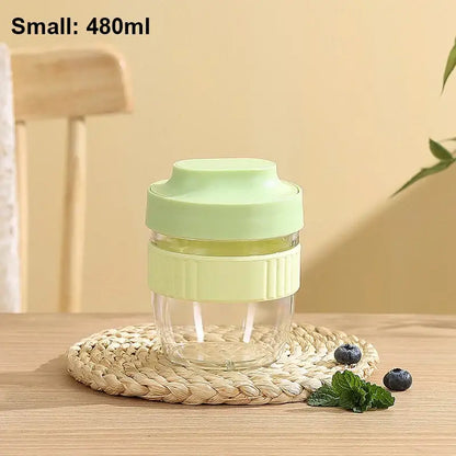A clear glass decorbites breakfast cup with a light green silicone lid and grip band 480ml small capacity
