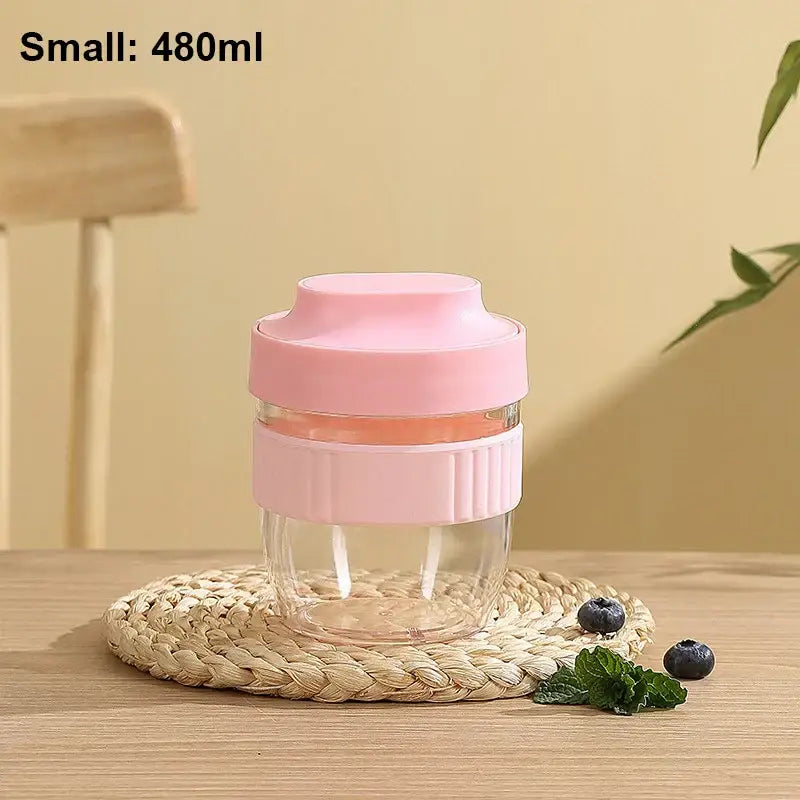 Mint green and yellow breakfast cup with pink silicone lid and grip band on clear glass decorbites breakfast cup