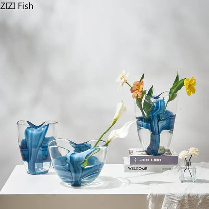 Clear glass vase with swirling blue striped patterns holding delicate flowers for modern living room decorbites decor