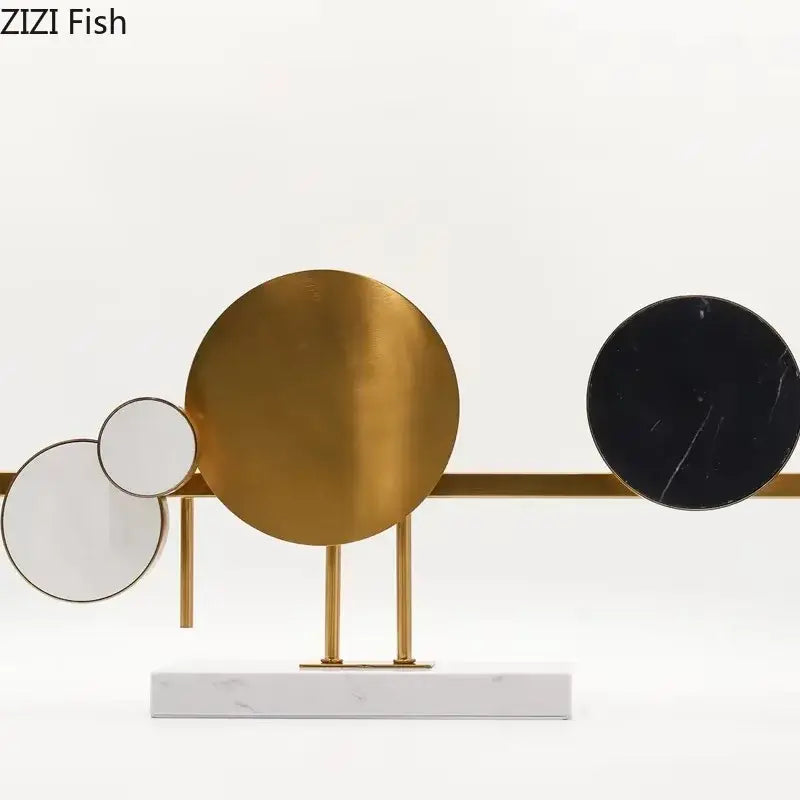 Modern abstract circular marble sculpture featuring gold black marble and mirrored discs in a brass frame for decorbites circular marble desk decor