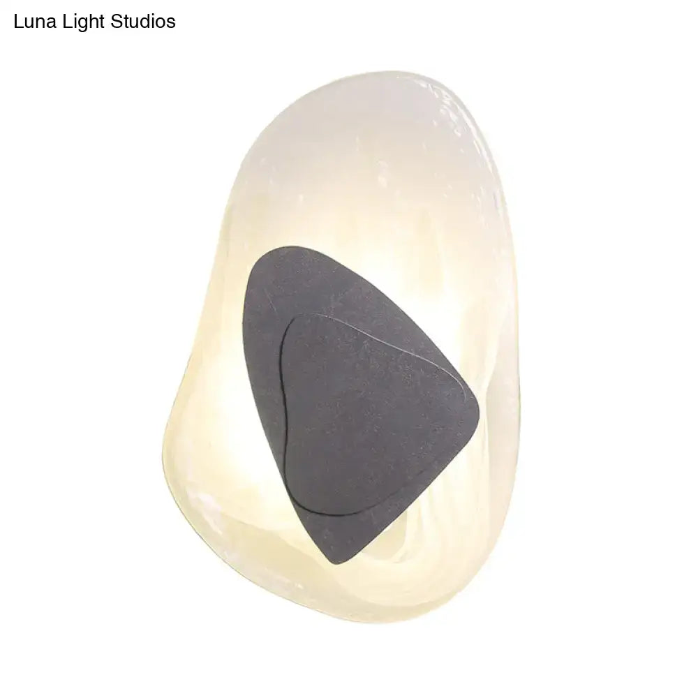 Modern abstract clear glass rock wall sconce with smooth white stone and dark gray triangular inlay for dining room direct wired electric