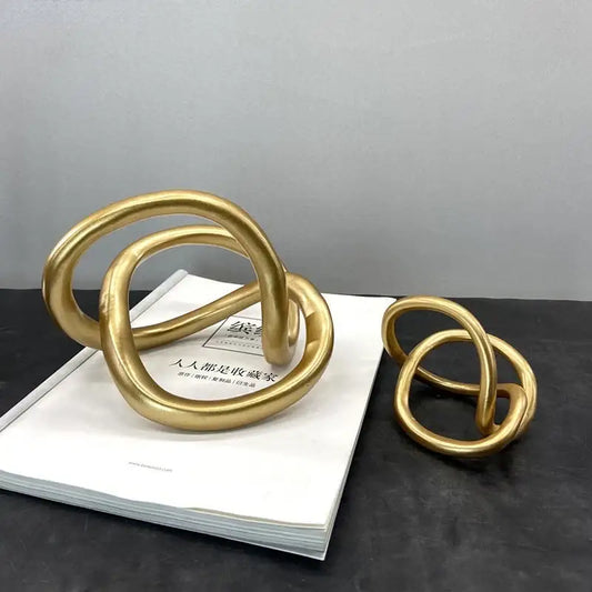 Modern abstract gold ring knot sculpture with smooth intertwined loops for living room art decor