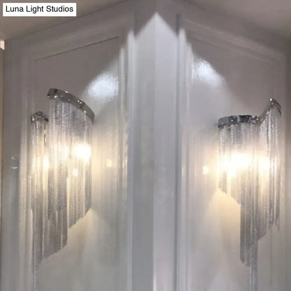 Modern abstract silver wall light featuring silver-toned wall sconces with cascading crystal chains and tassel aluminum shade