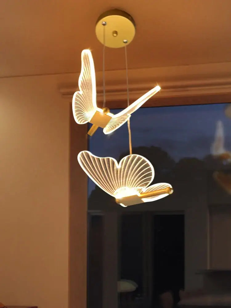 Modern acrylic gold-toned butterfly led chandelier with illuminated translucent wings for bedroom pendant lighting decorbites butterfly led