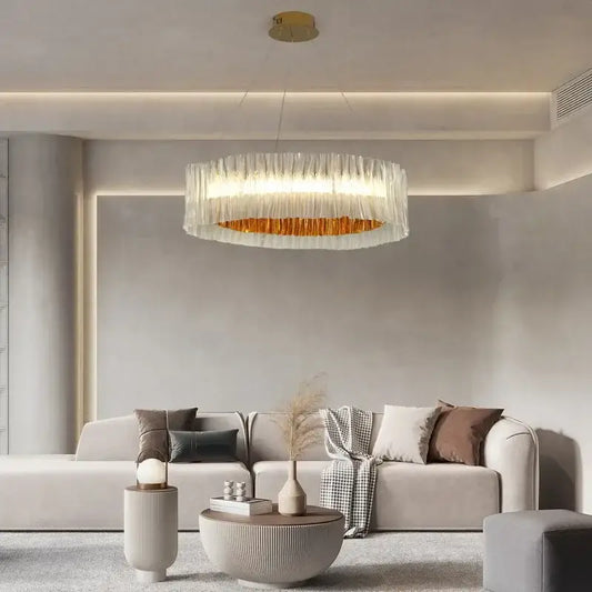 Modern acrylic ceiling chandelier with a gold ring and translucent glass panels for dining room lighting
