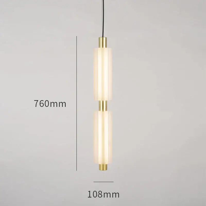 Modern acrylic minimalist pendant lights featuring two frosted glass cylinders with brass accents on black cords