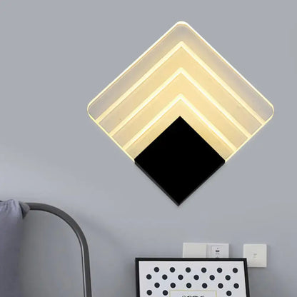 Modern aged silver and black square led wall sconce with diamond-shaped layered translucent panels for bedroom lighting