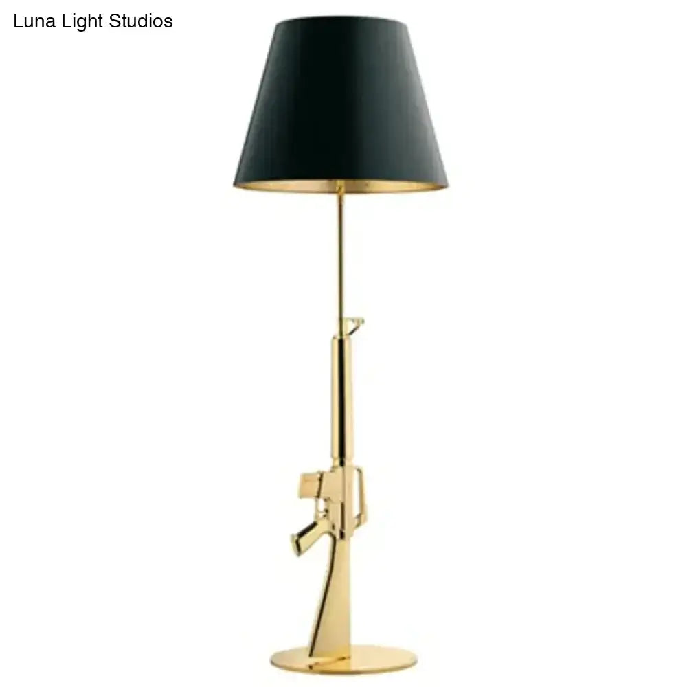 Modern ak47 gun lounge floor lamp in silvery gold lustre with black conical shade and gold interior trim for bedrooms