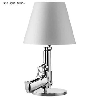 Modern ak47 gun lounge floor lamp with chrome finished pistol base and white tapered shade for bedroom lighting