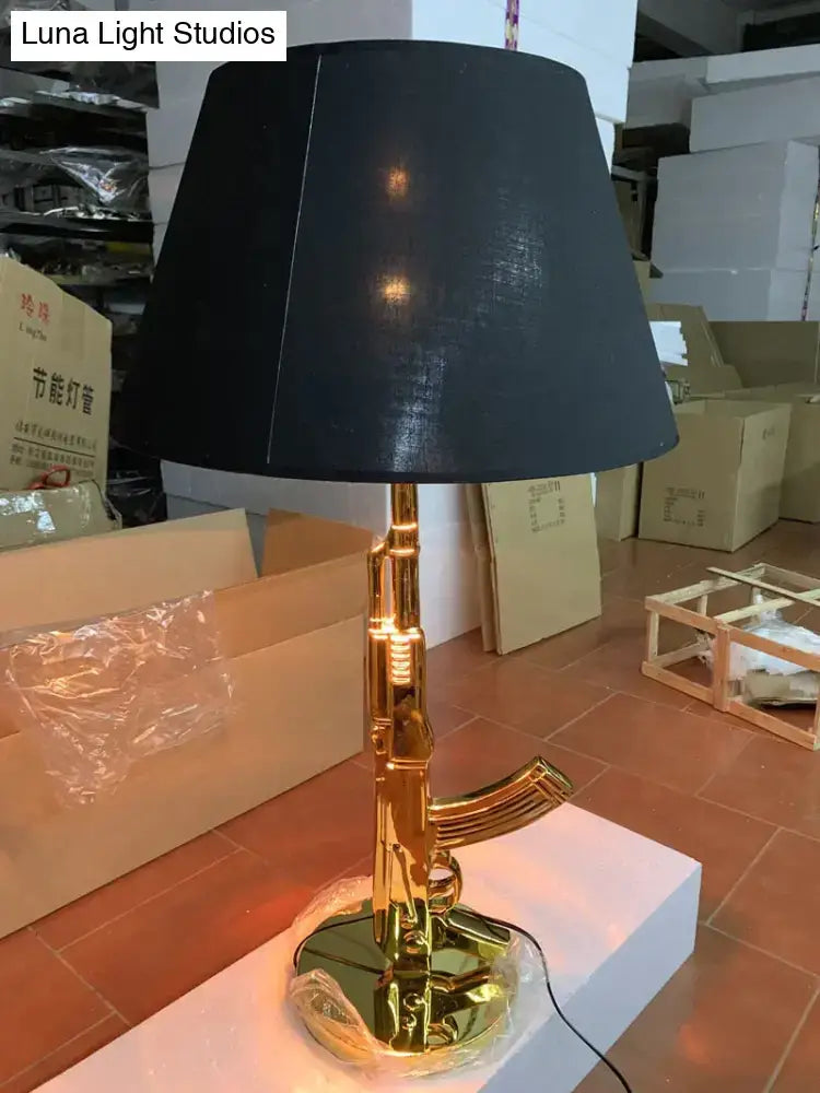 Modern ak47 gun lounge floor lamp in silvery gold lustre with black fabric shade for bedroom lighting