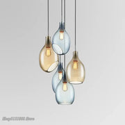 Modern amber and blue glass pendant lights with warm bulbs designed as kitchen pendant lights