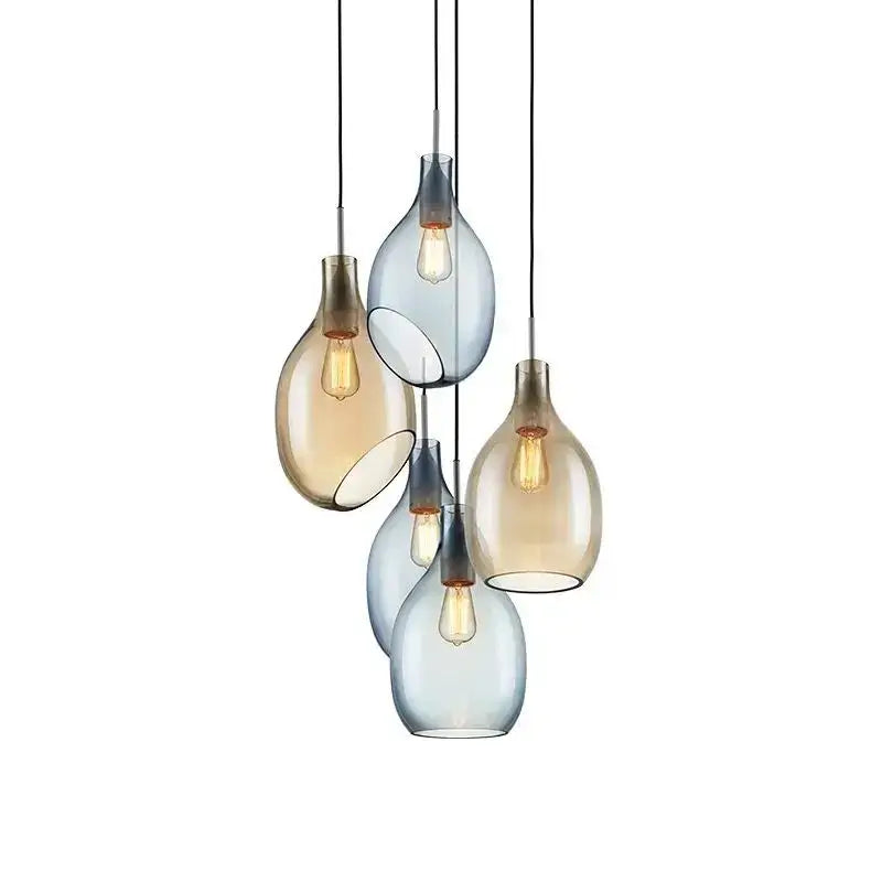 Modern amber and blue glass pendant lights with five teardrop-shaped shades and warm filament bulbs for kitchen use
