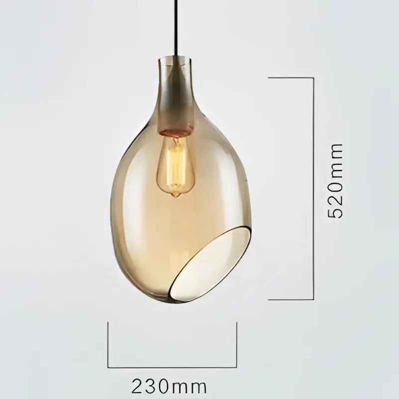 A sleek amber glass pendant light with vintage edison bulb and metallic accents for modern kitchen lighting