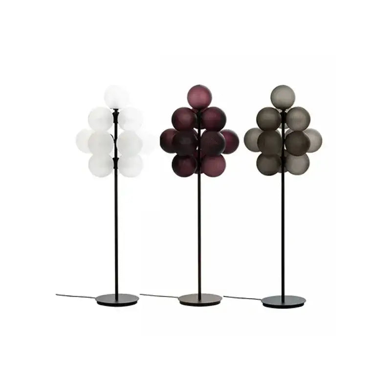 Modern amber bubble glass lamp set with black metal stands and white, deep purple, and gray globes for living room
