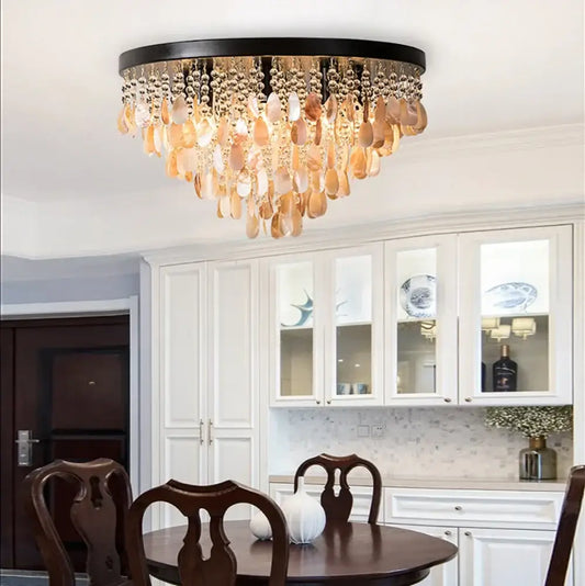 Modern amber and clear crystal led ceiling lamp with black frame and cascading shell pendants for living room decorbites crystal led
