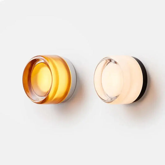 Modern amber and cream glass sconce led wall lamp with translucent shades on sleek metallic bases for living room use