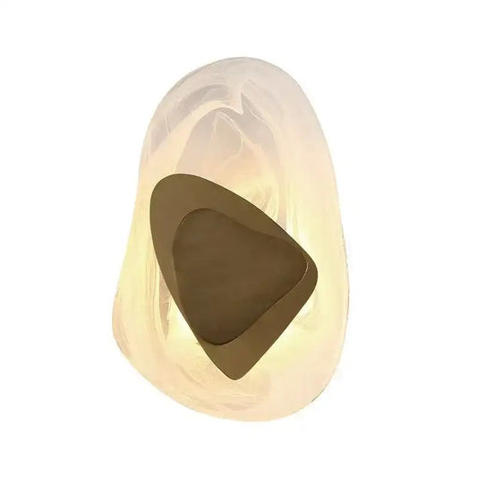 Modern amber crystal wall lamp with a smooth translucent glass sculpture and bronze triangular cutout decorbites crystal wall
