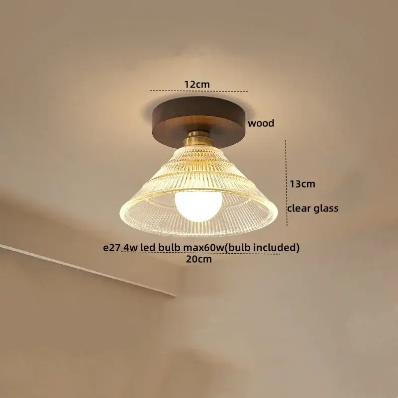 Modern amber glass and brass led ceiling lamp with dark wood base and clear ribbed glass shade for dining room