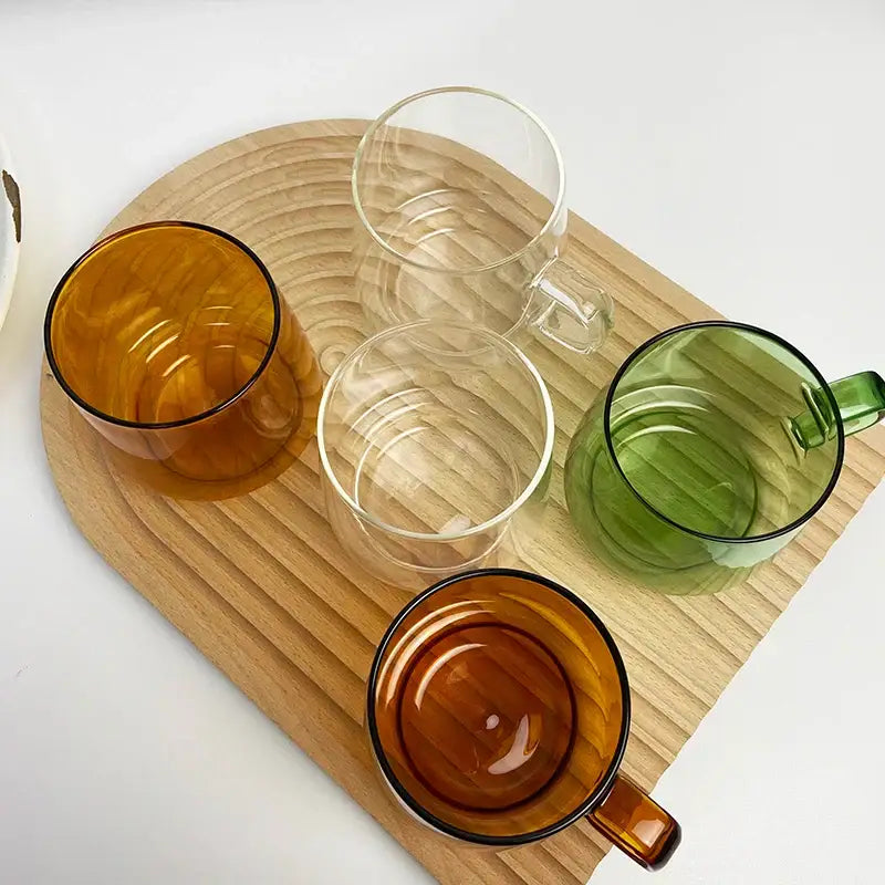 Set of four decorbites glass coffee mugs in amber clear and green with black rims for kitchen and dining room use