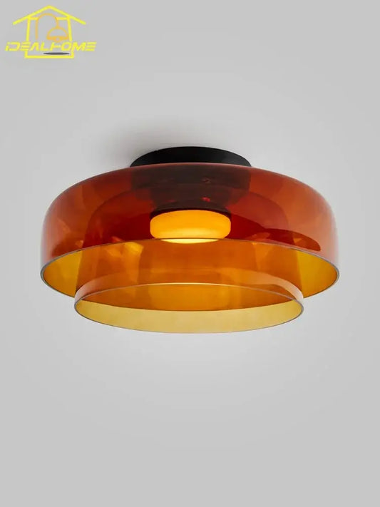 A modern amber glass led ceiling light with layered translucent shade and black base for living room ceiling light